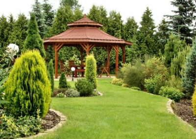 An open space with plants, trees and a gazebo